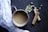 Close-up of a steaming cup of chai tea with floating cardamom pods and a rustic wooden table background.