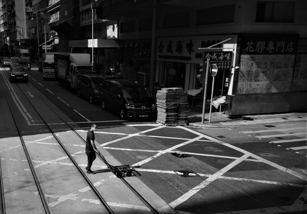 a black and white photo of a man walking down a street