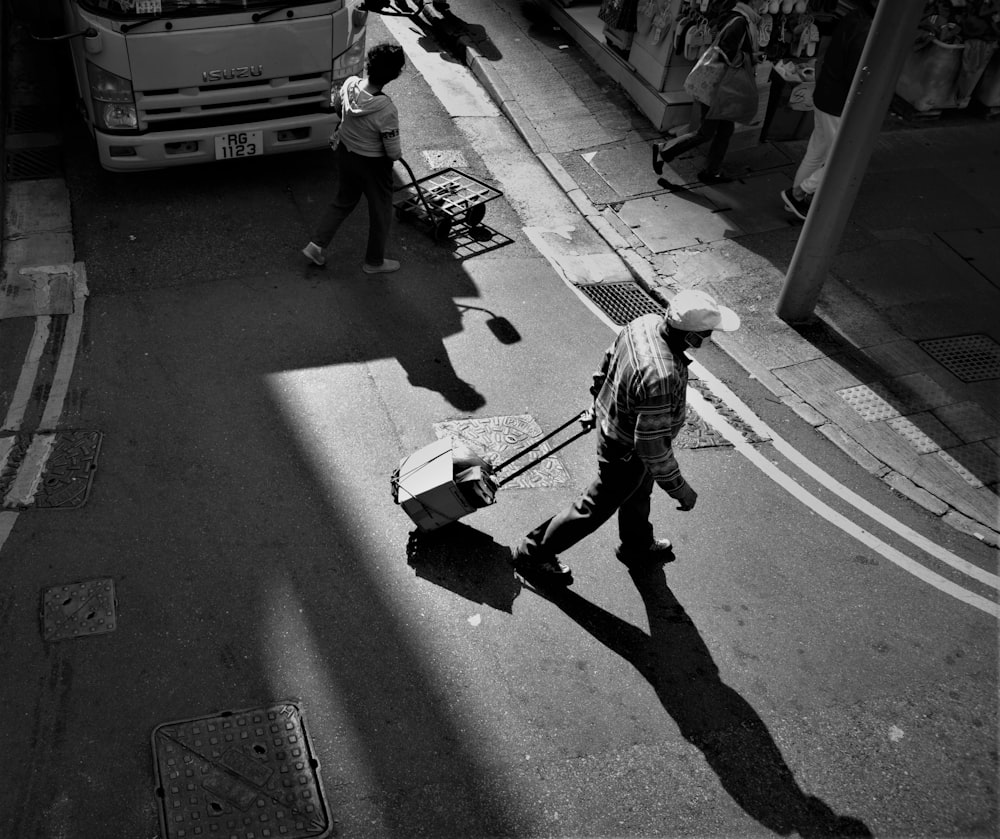 a black and white photo of a man walking down the street