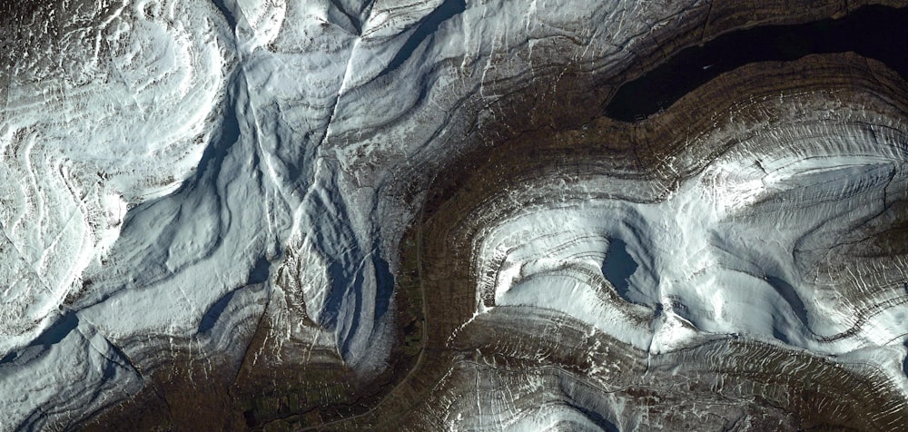 an aerial view of a snow covered mountain range