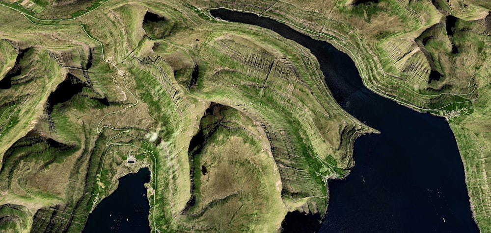 an aerial view of a lake surrounded by mountains