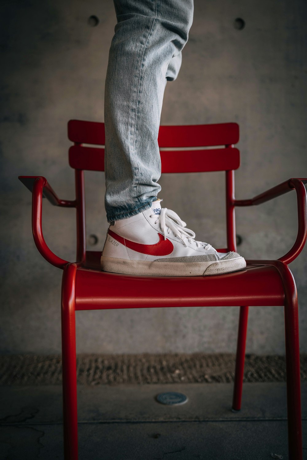 a person standing on top of a red chair