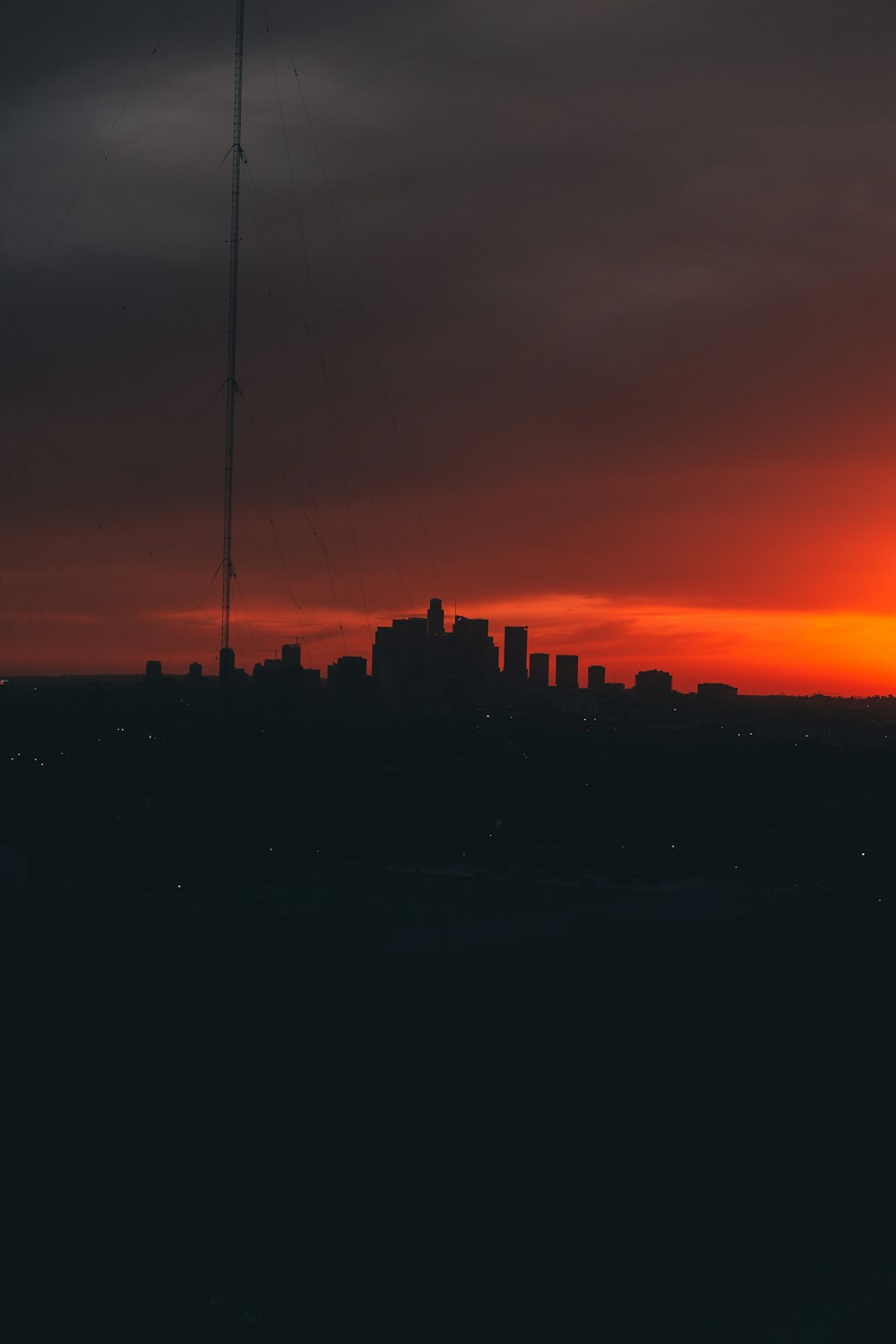 the sun is setting over a city skyline