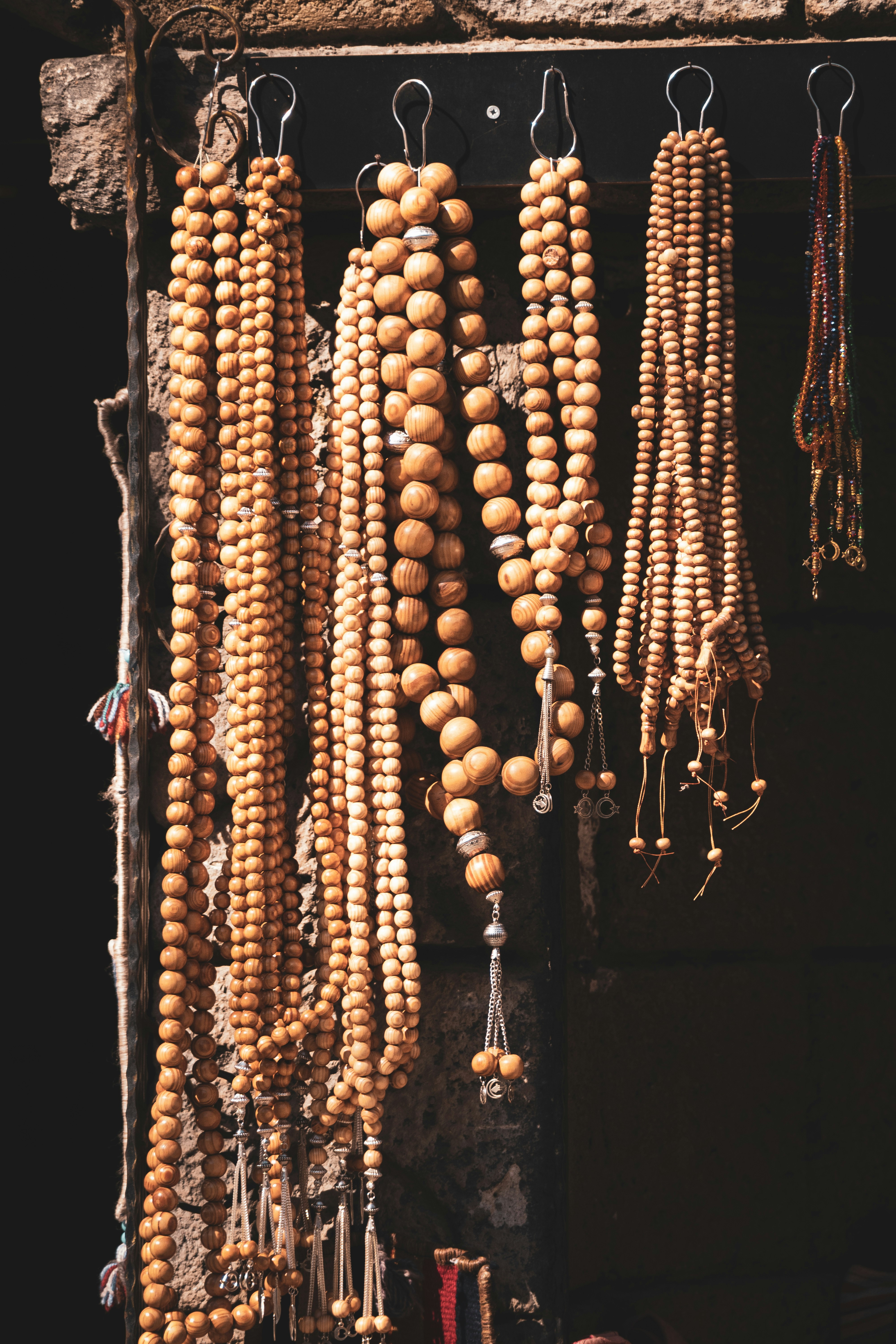 a bunch of wooden beads hanging from hooks