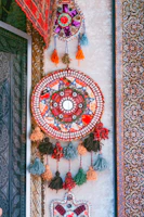 Close-up of a handcrafted wall hanging showcasing intricate designs.