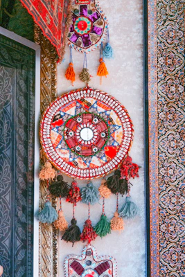 Beautiful handcrafted torans and wall hangings featuring bright colors and intricate designs.