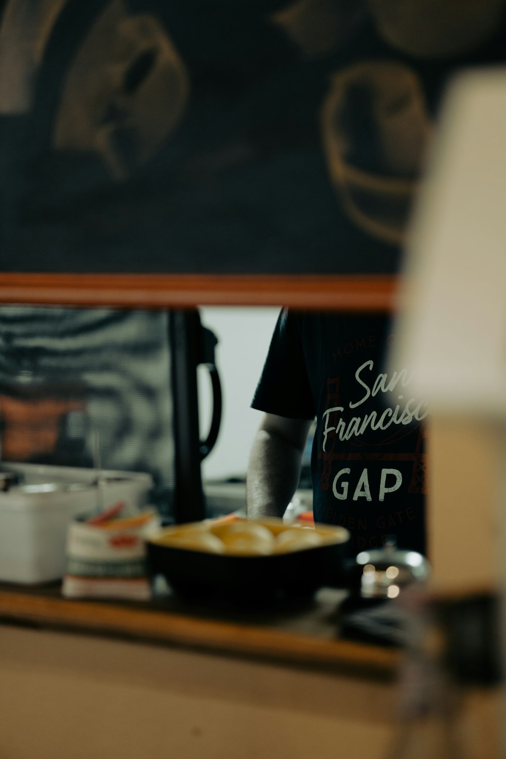 a person standing in front of a counter with food on it