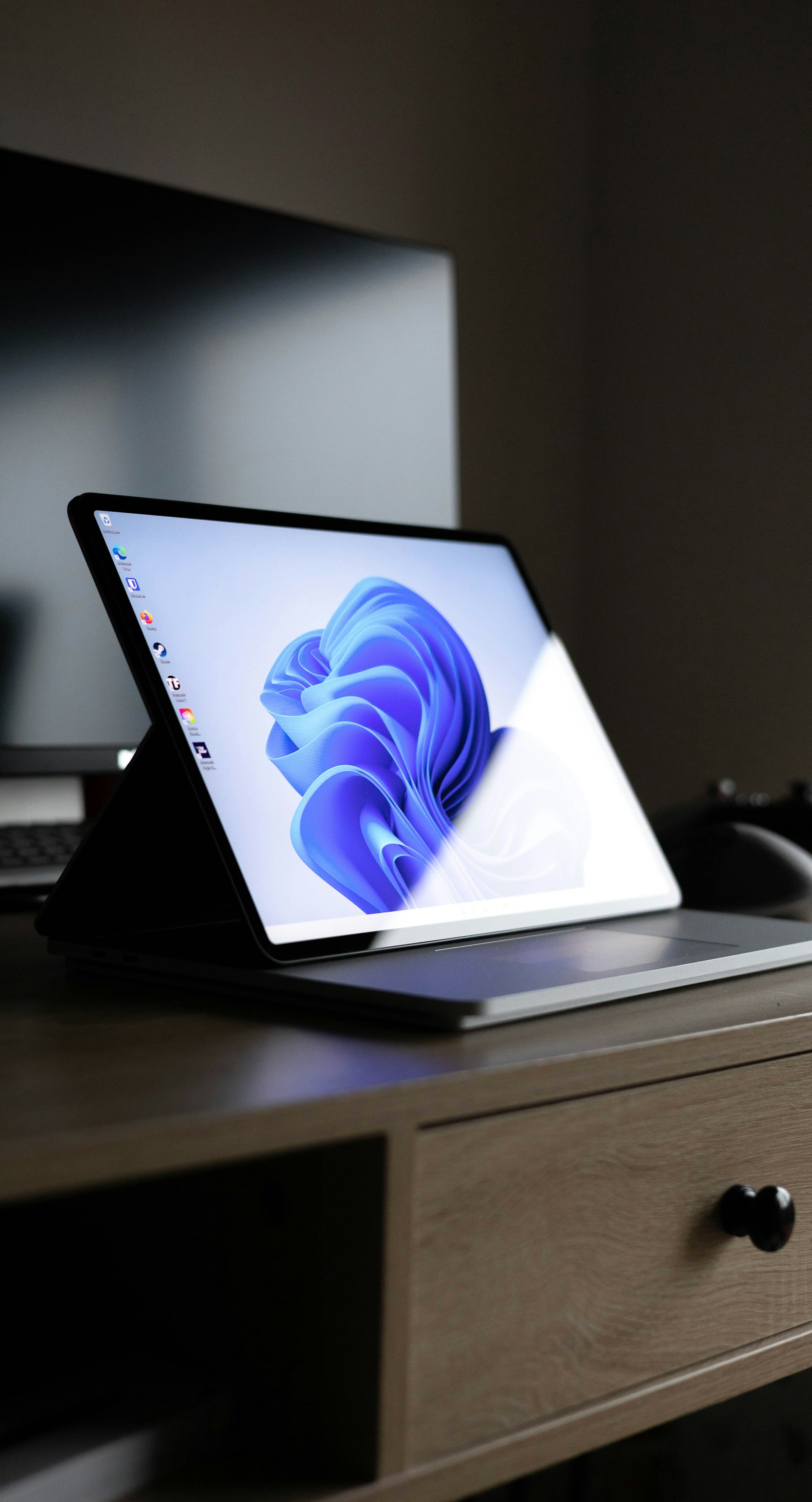 a laptop computer sitting on top of a wooden desk