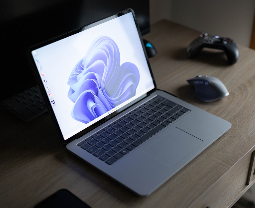 a laptop computer sitting on top of a wooden desk