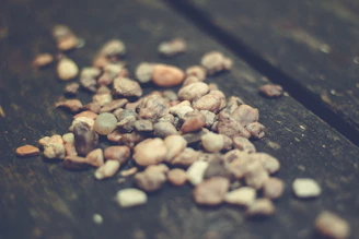Variety of smooth river stones arranged neatly on a wooden surface