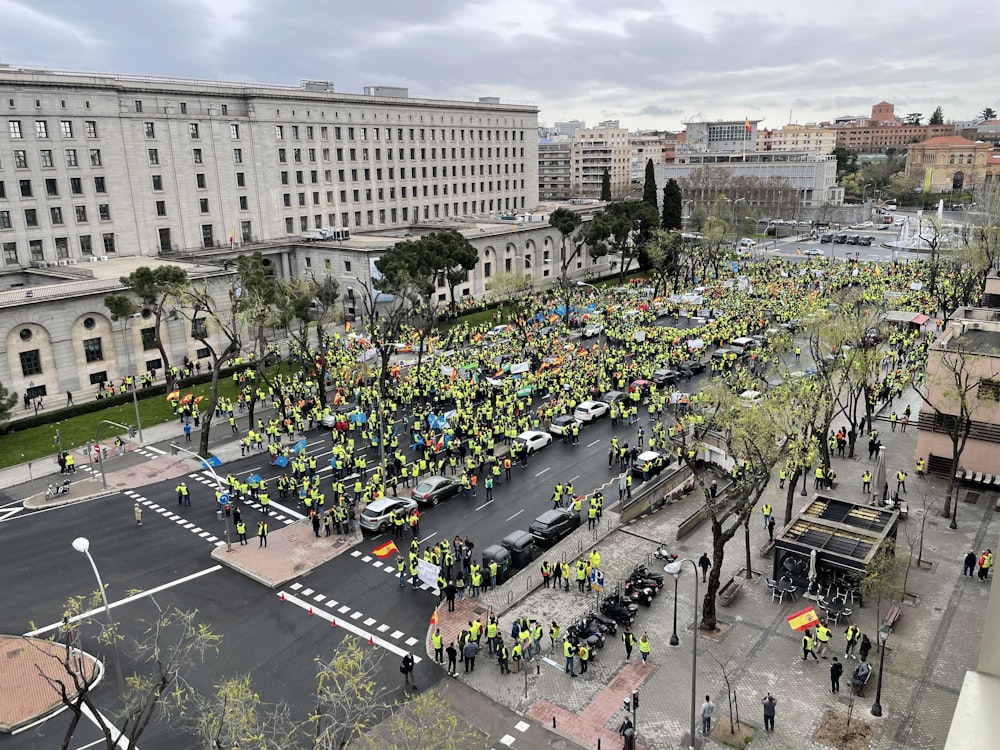 a large group of people standing in the middle of a street