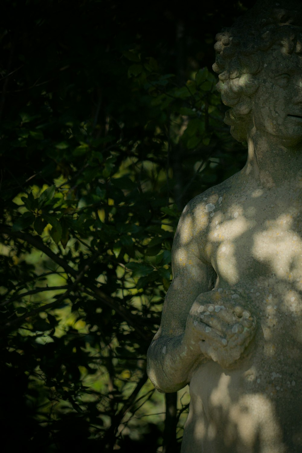 a statue of a man holding a bird in his hands