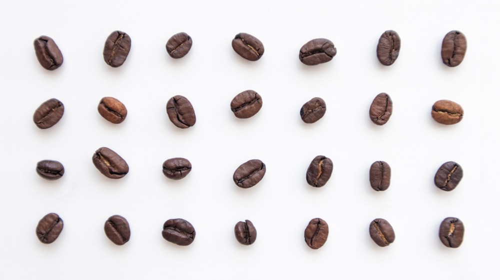 a group of coffee beans on a white background