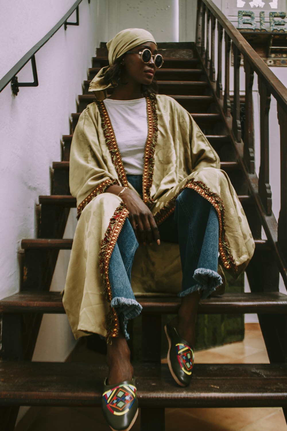 a woman sitting on top of a set of stairs