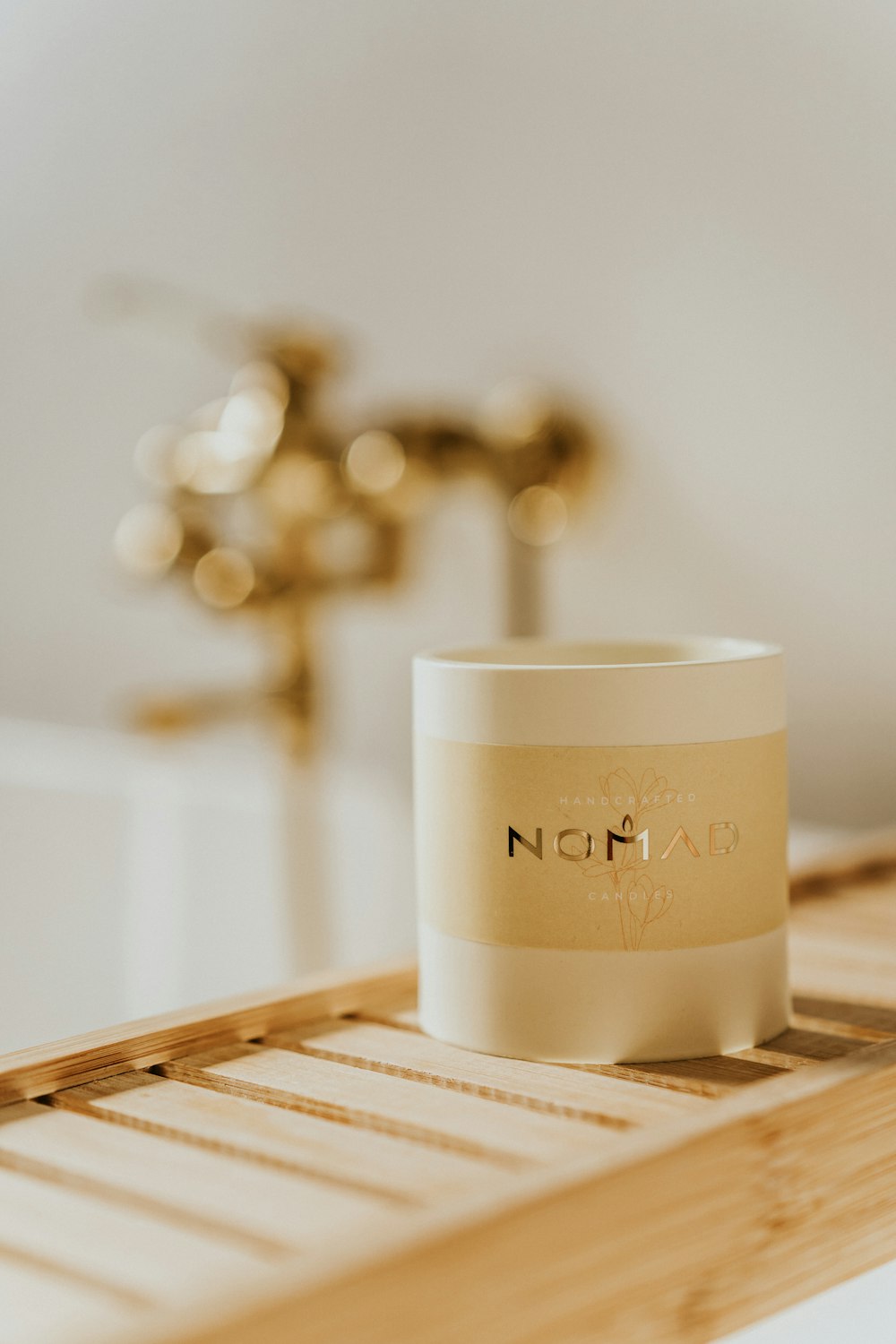 a white cup sitting on top of a wooden tray