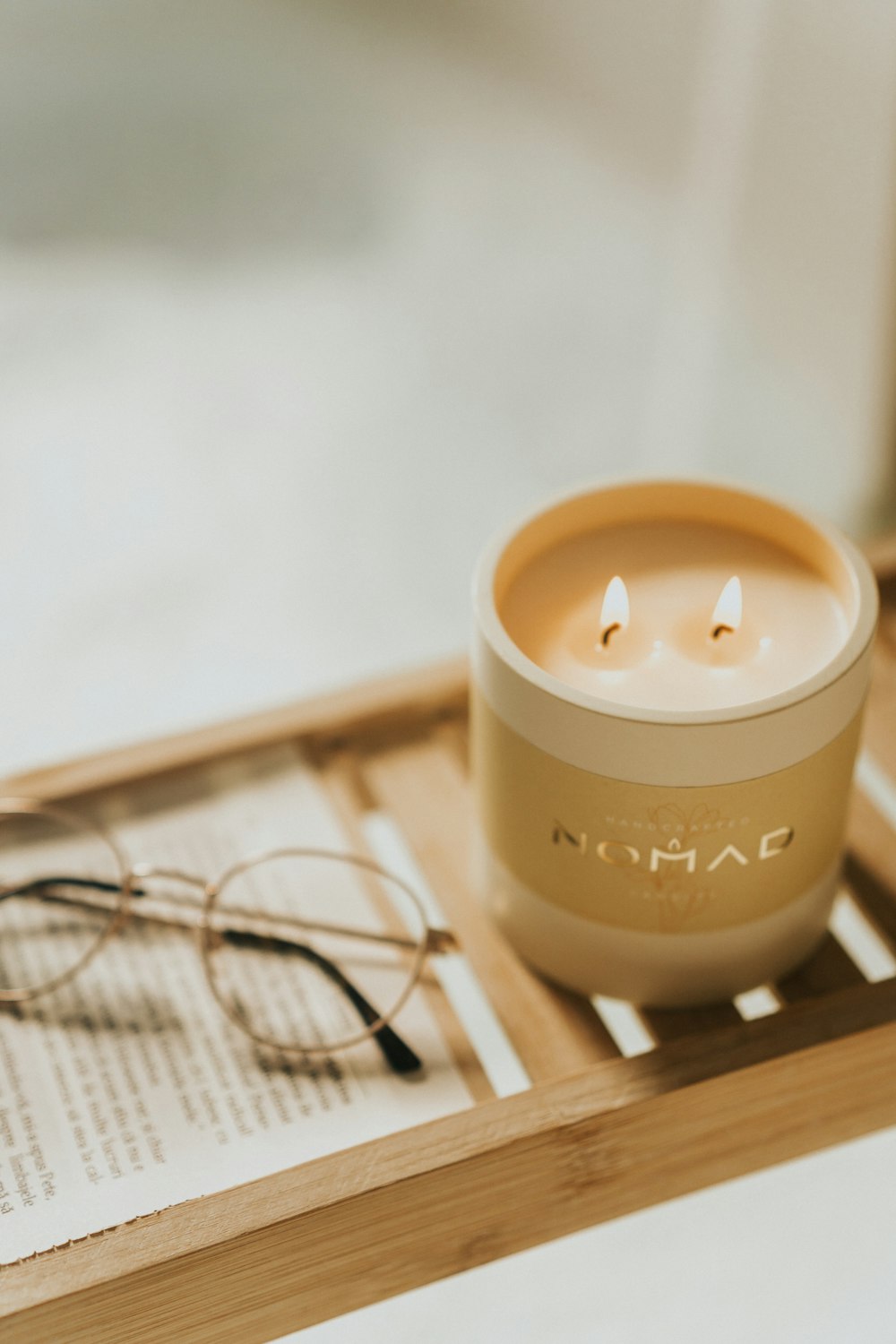 a pair of glasses sitting on top of a table next to a candle