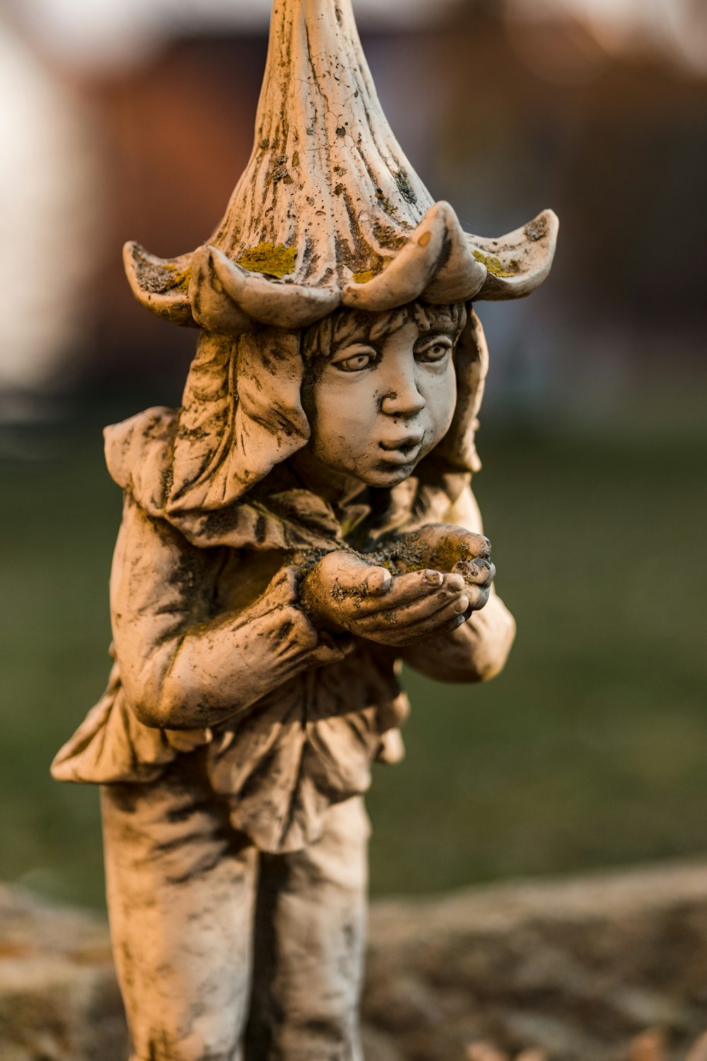 a statue of a little girl holding a bird