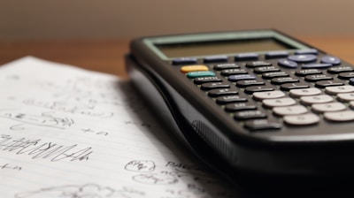 a calculator sitting on top of a piece of paper