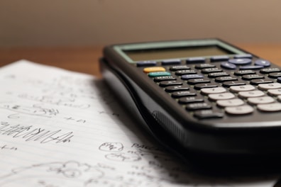 a calculator sitting on top of a piece of paper