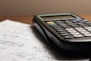 a calculator sitting on top of a piece of paper