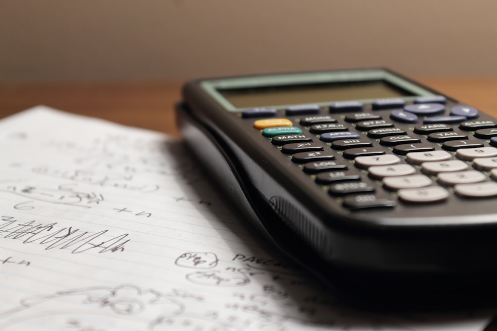 a calculator sitting on top of a piece of paper