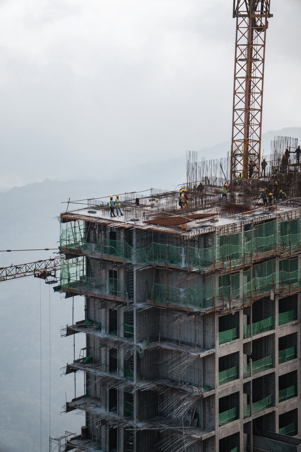 a tall building with a crane on top of it