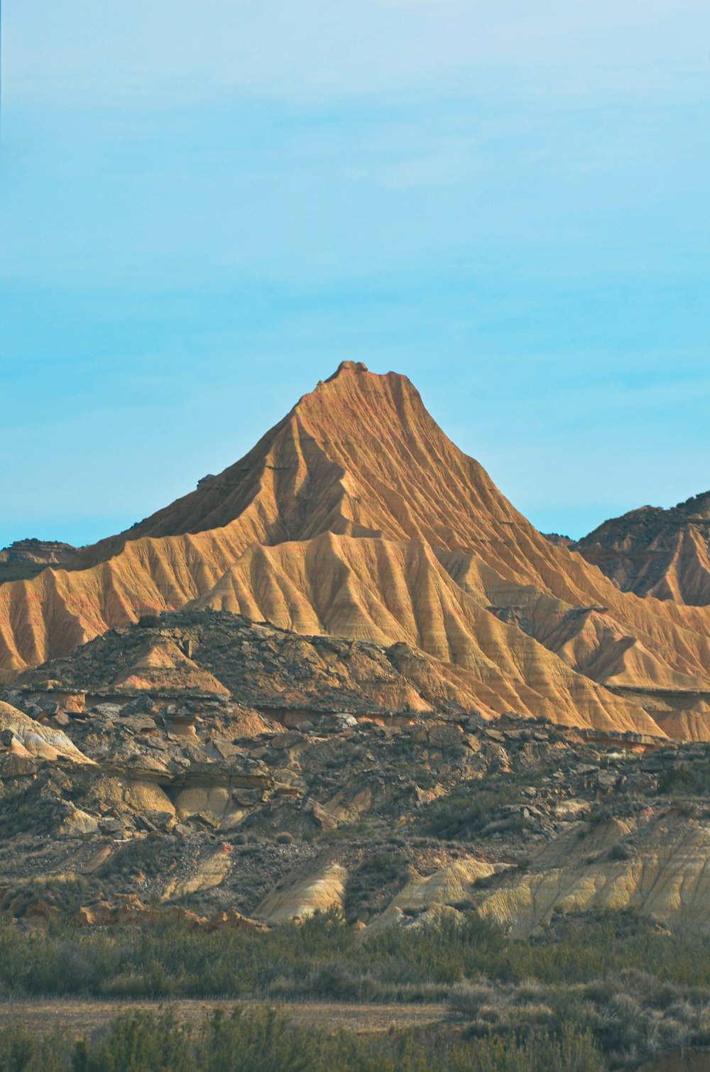 a mountain range with a few trees in the foreground