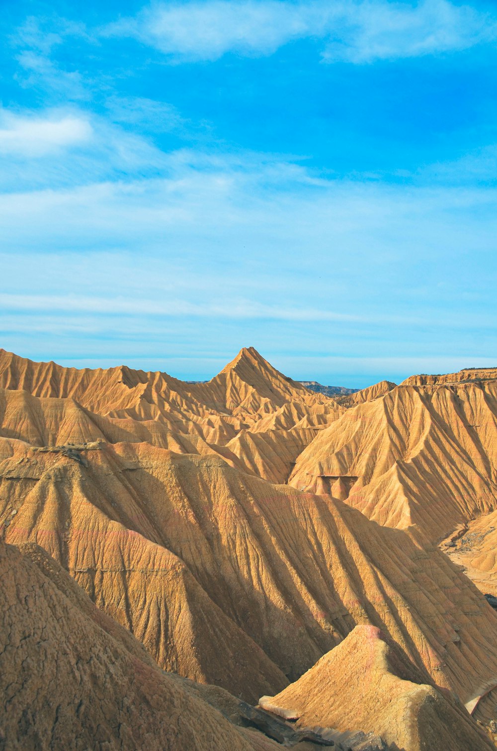 a view of a mountain range with a blue sky in the background