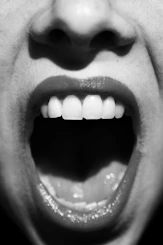 a close up of a person with their mouth open