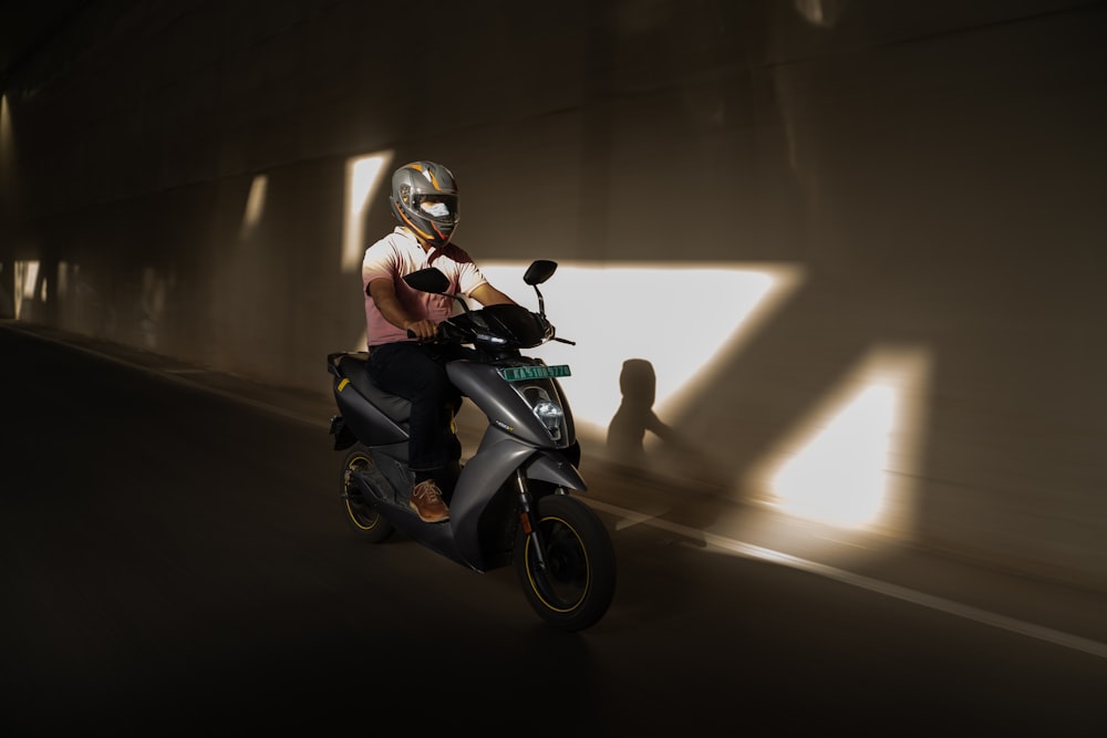 a person riding a motorcycle in a tunnel