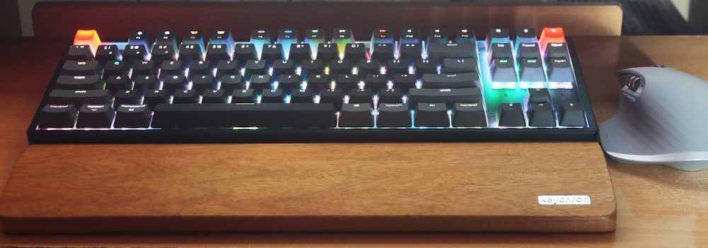 a close up of a keyboard and a mouse on a desk