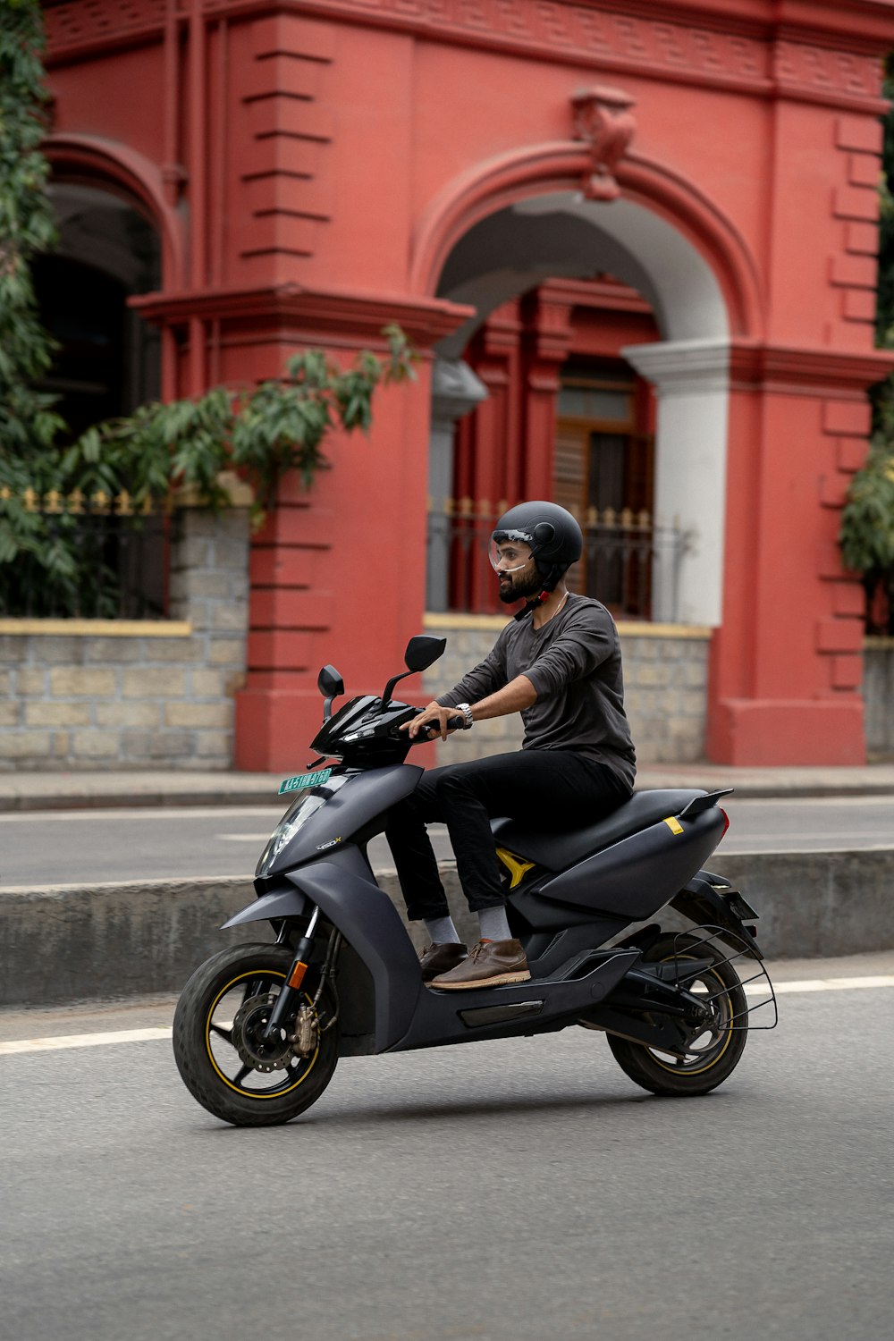 a man riding a scooter on a city street