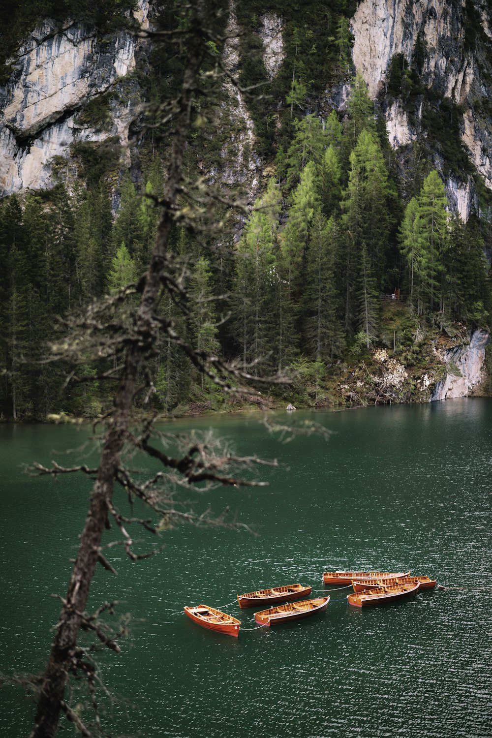 a couple of boats floating on top of a lake