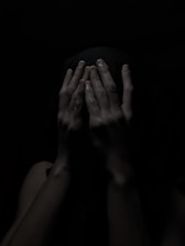 A shadowy figure in a dark alley, symbolizing secrecy and confidentiality.