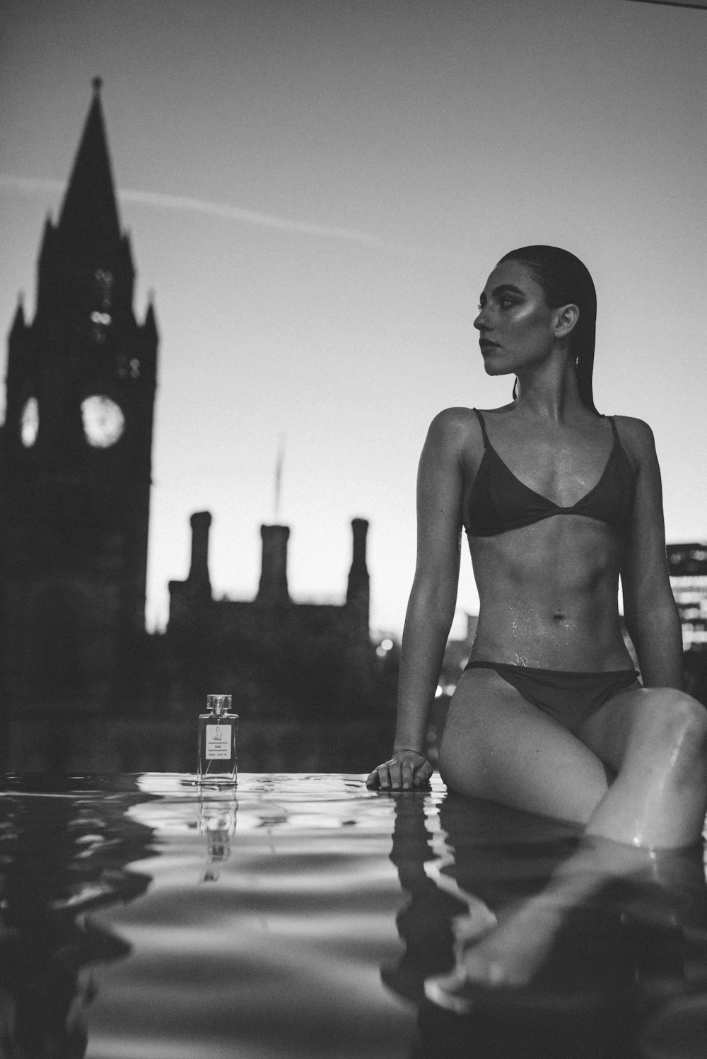 a woman in a bikini sitting in the water