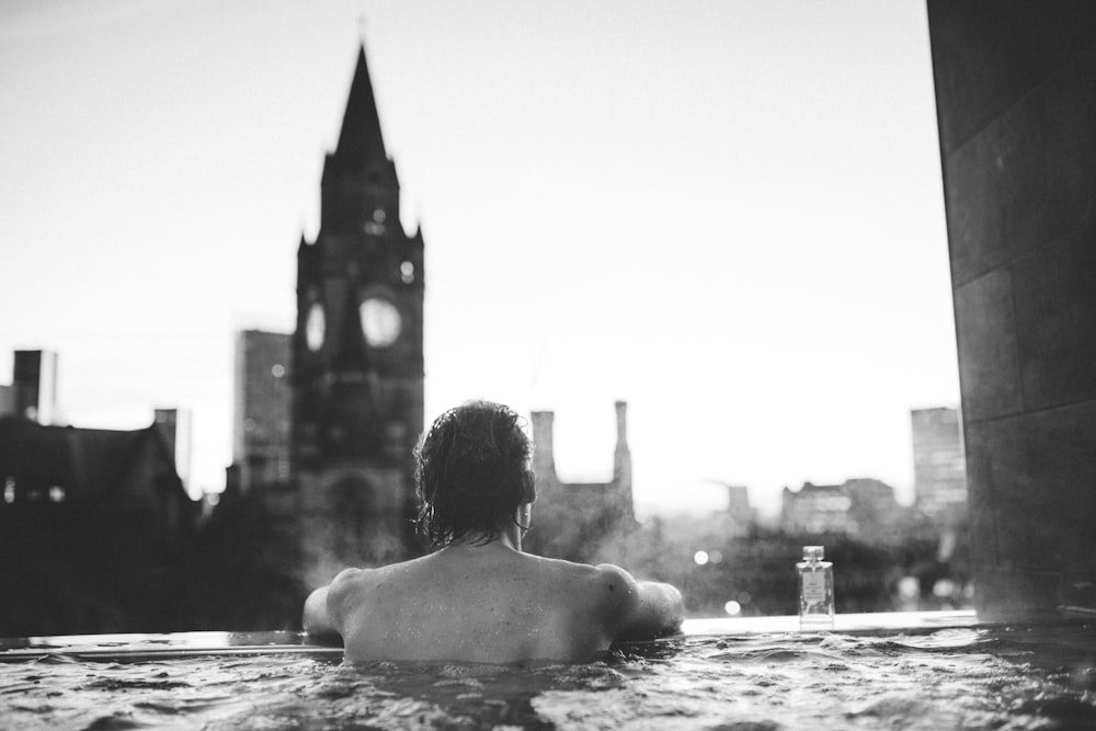a person sitting in a hot tub in a city