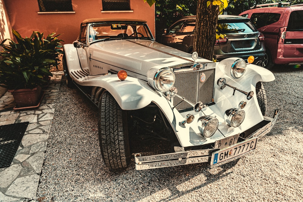 a vintage car is parked on the side of the road