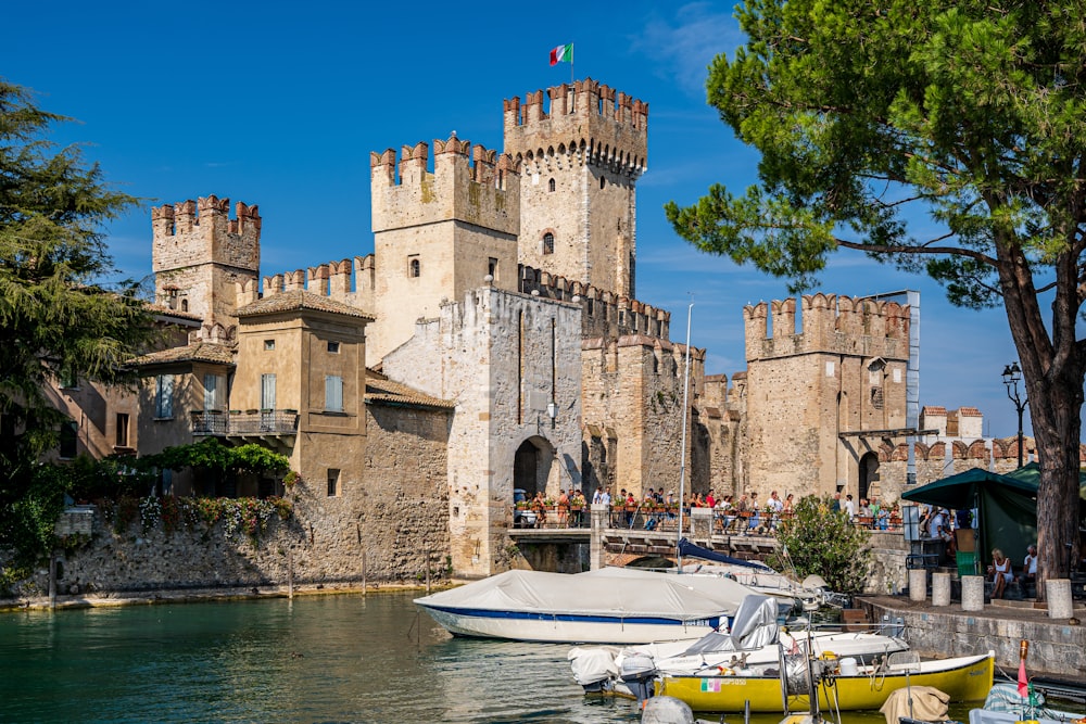 a boat is docked in front of a castle