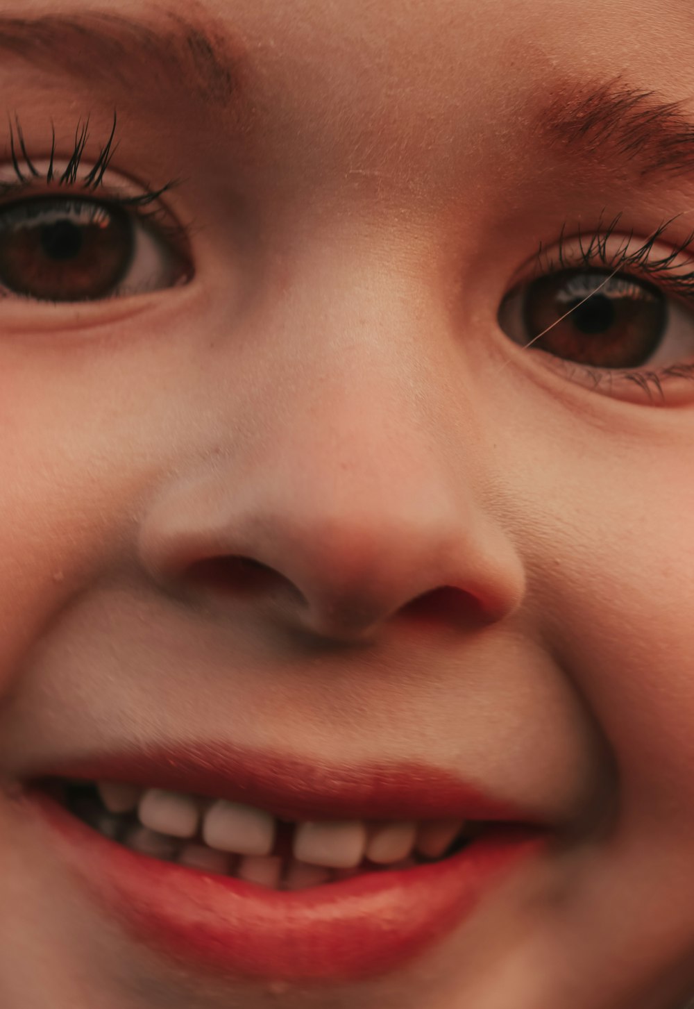 a close up of a child's face smiling