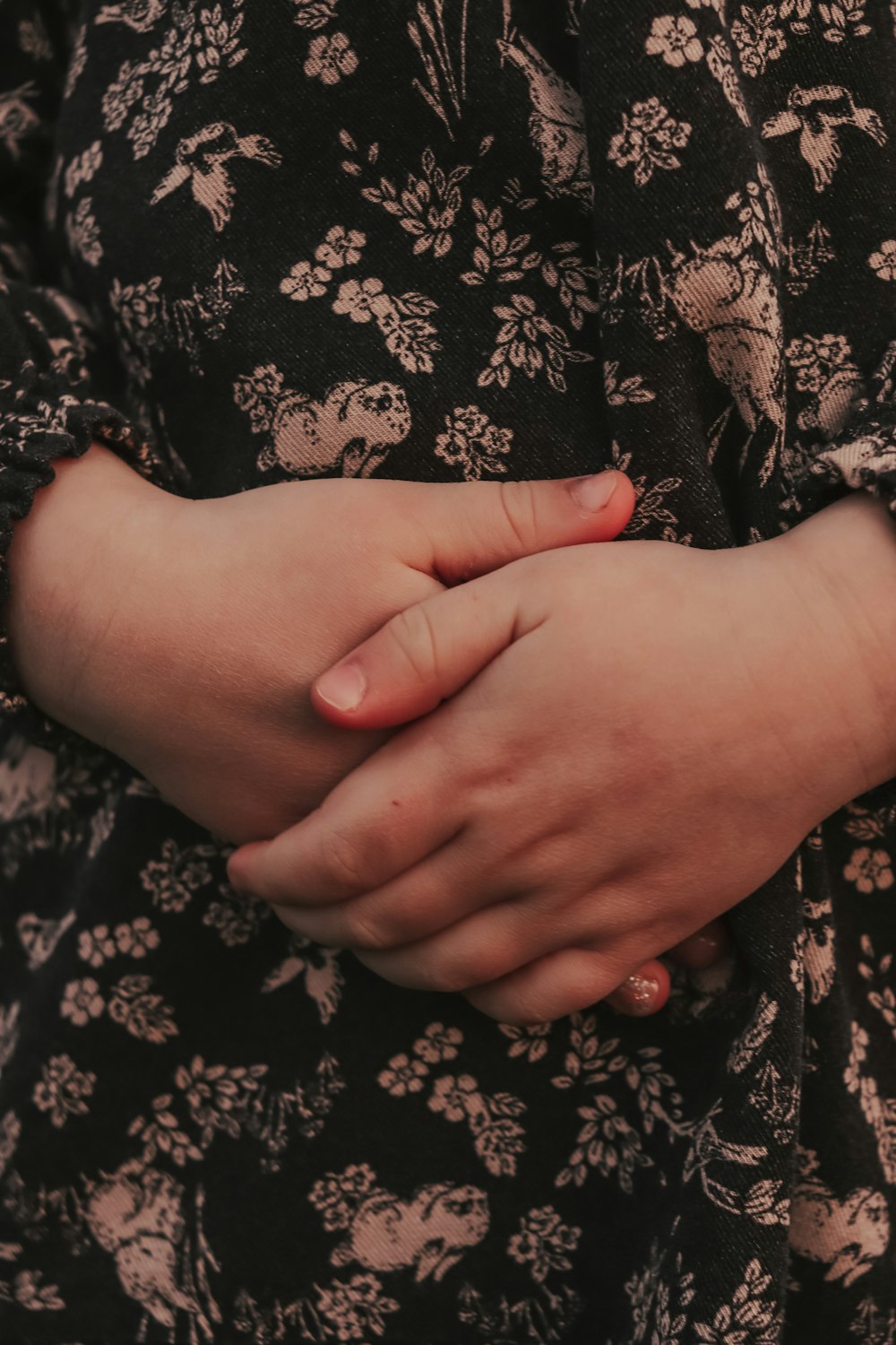 a close up of a person holding their hands together