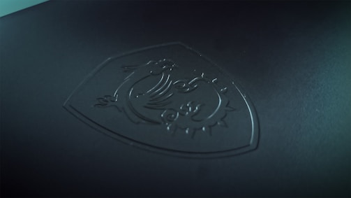 a close up of a logo on a black surface