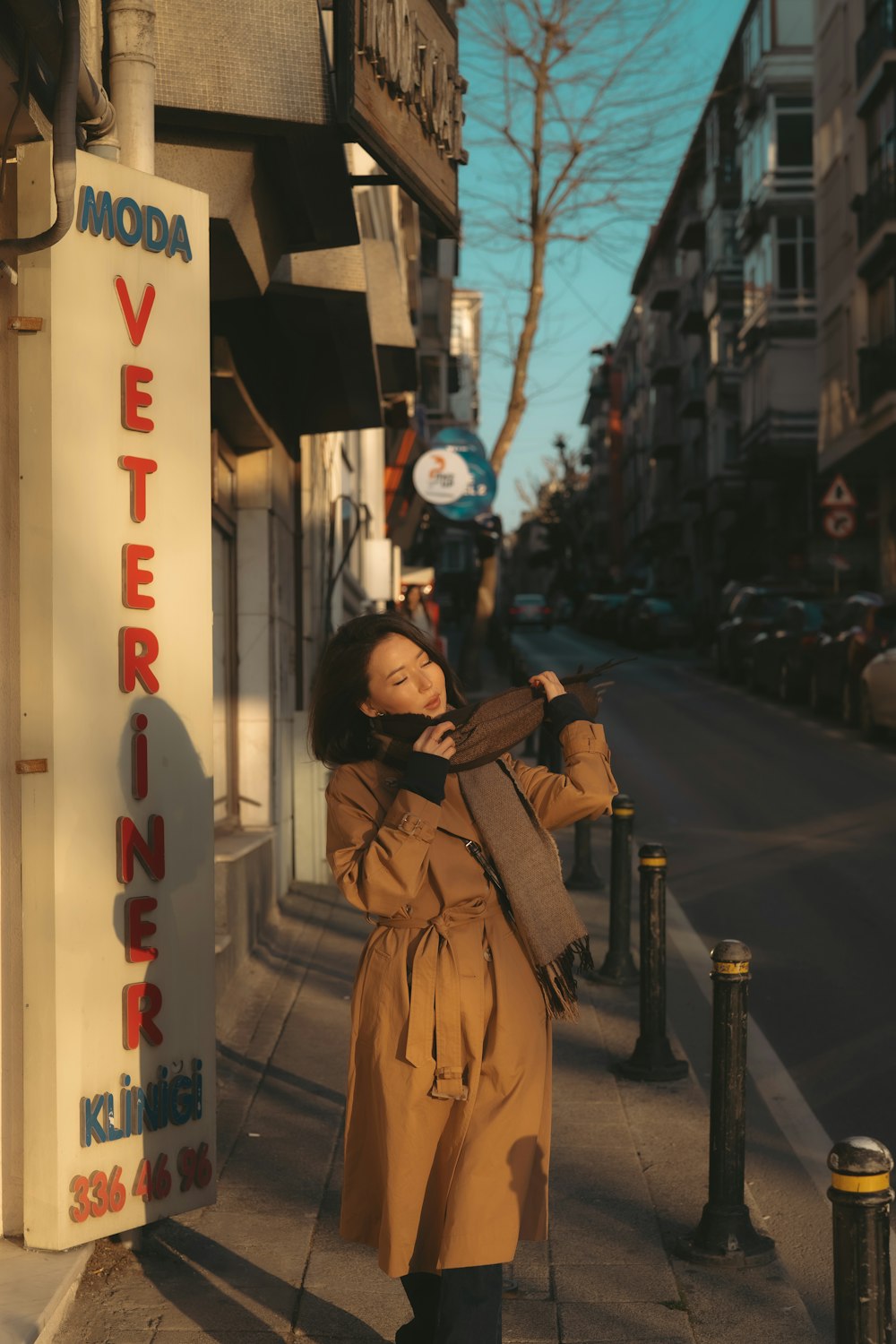 a woman standing on a sidewalk taking a picture