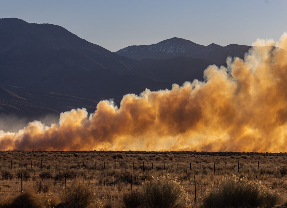 a large amount of smoke billowing out of the sky