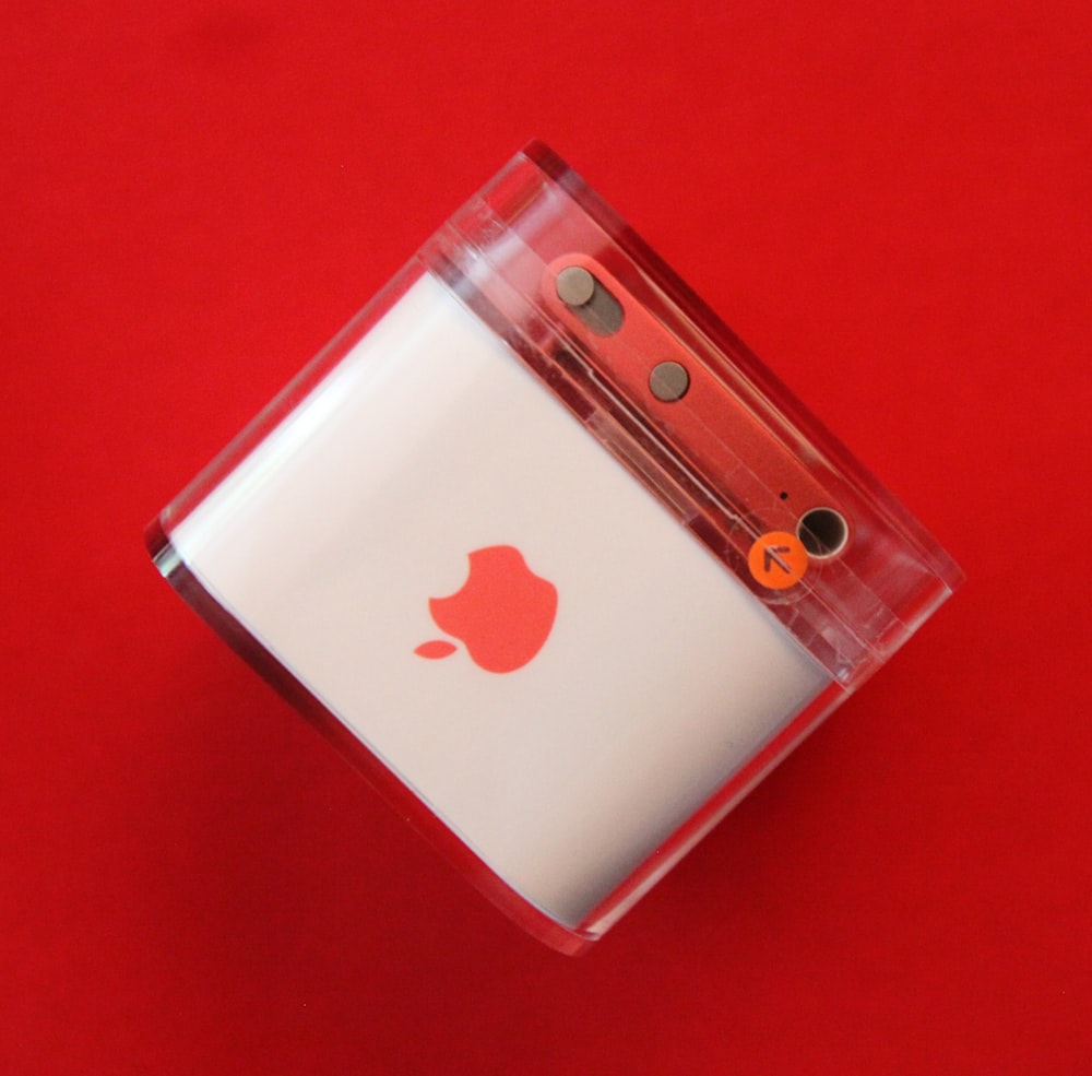 an apple product in a package on a red background