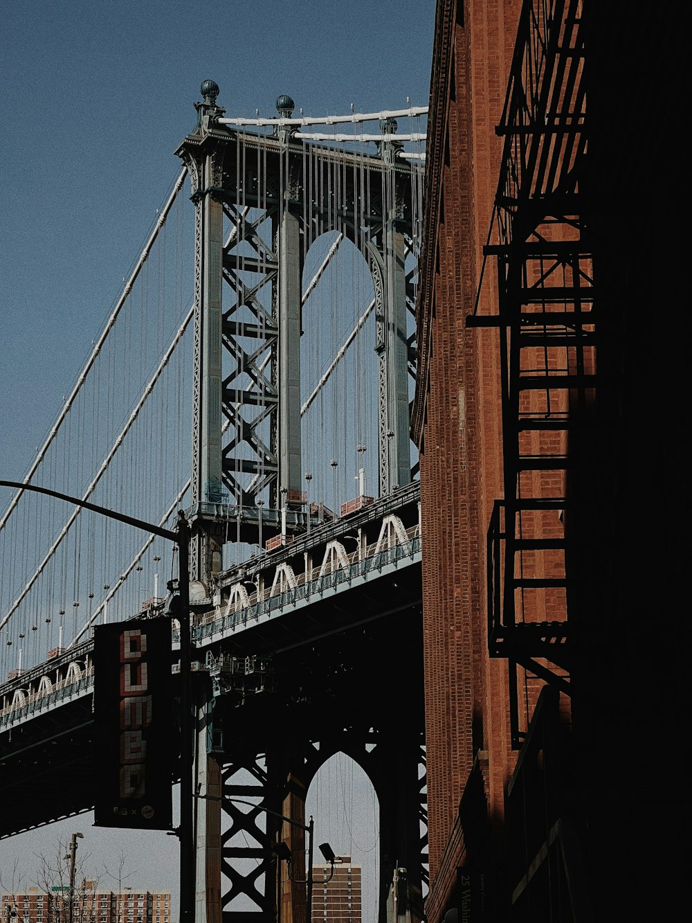 a large bridge spanning over a city with tall buildings