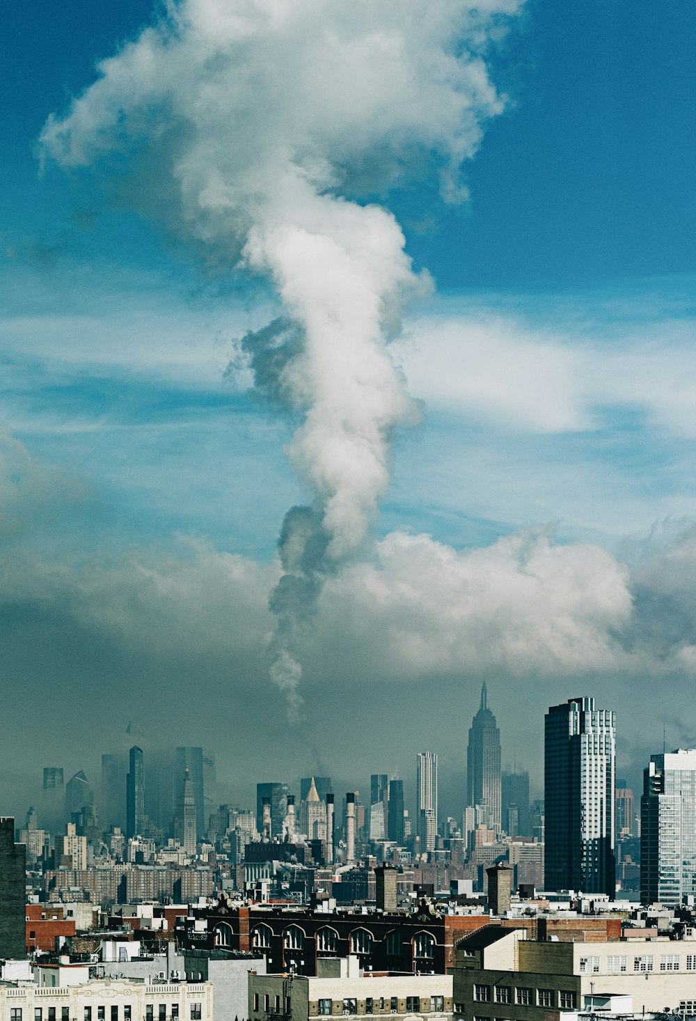 a large plume of smoke is coming out of a building