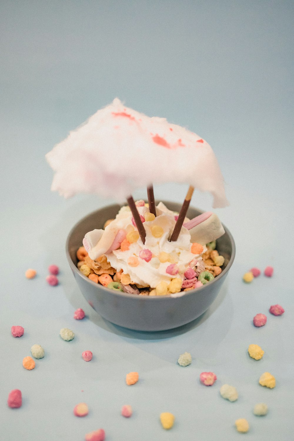 a bowl of cereal with marshmallows and an umbrella