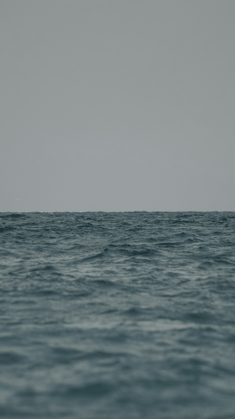 a large body of water with a boat in the distance