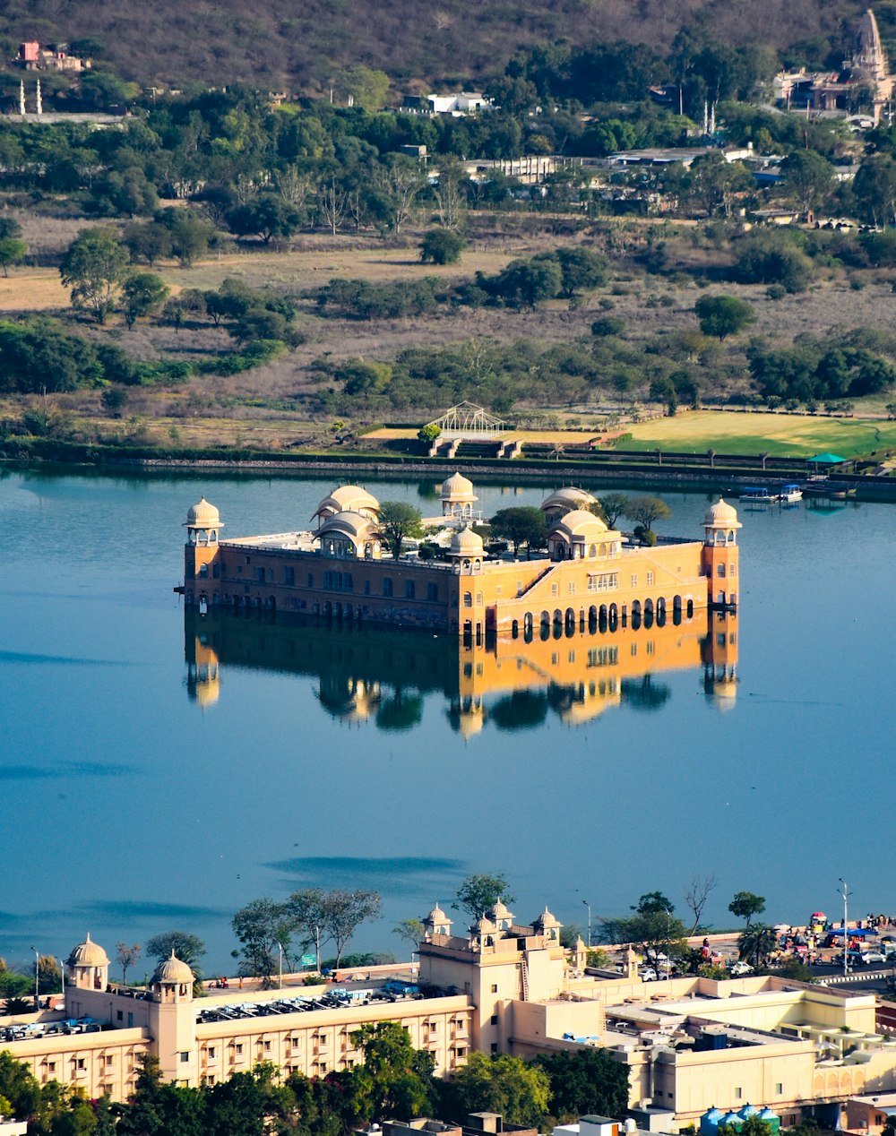 an aerial view of a castle in the middle of a lake