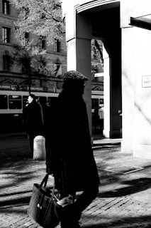 Dynamic street photography capturing urban life with contrasting shadows and highlights.